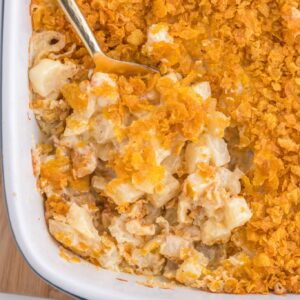 Funeral Potatoes are a delicious side dish with frozen diced hash brown potatoes baked in a creamy, cheesy mixture and topped with crushed cornflakes.