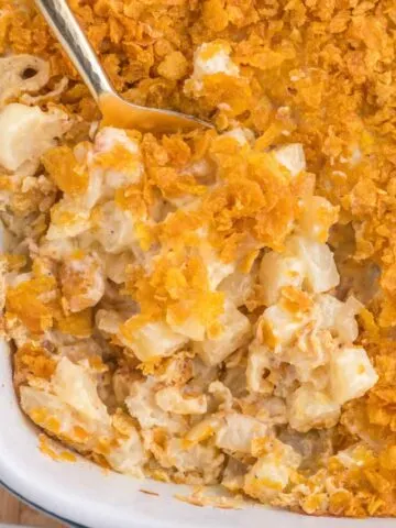 Funeral Potatoes are a delicious side dish with frozen diced hash brown potatoes baked in a creamy, cheesy mixture and topped with crushed cornflakes.