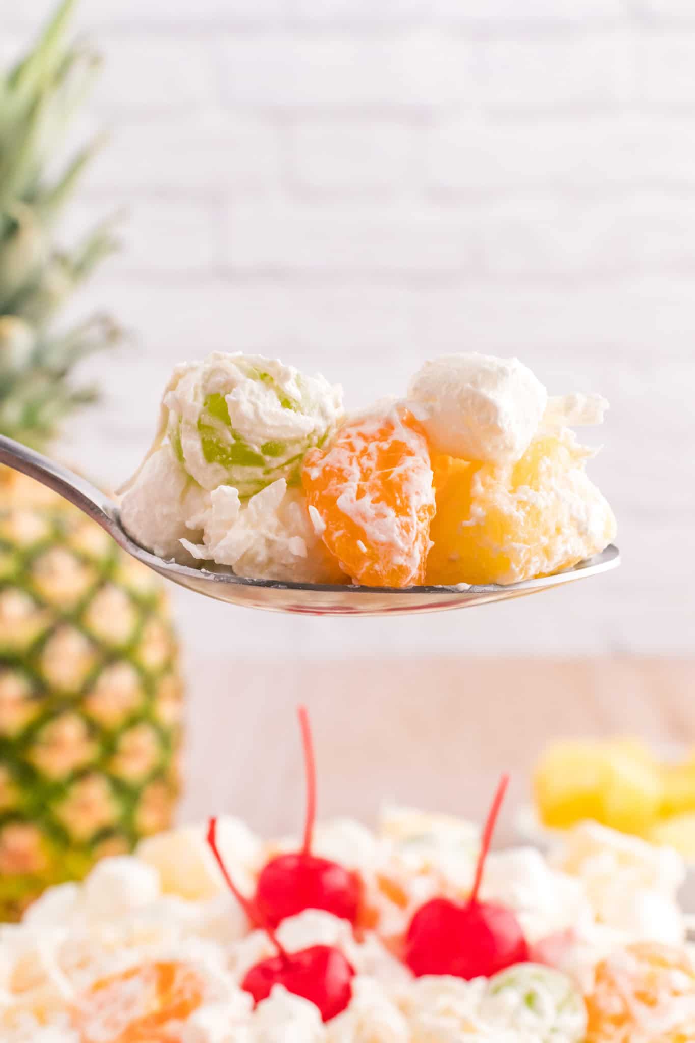 Hawaiian Ambrosia Salad is a sweet and creamy fruit salad recipe loaded with pineapple, mandarins, grapes, shredded coconut, mini marshmallows and Cool Whip.