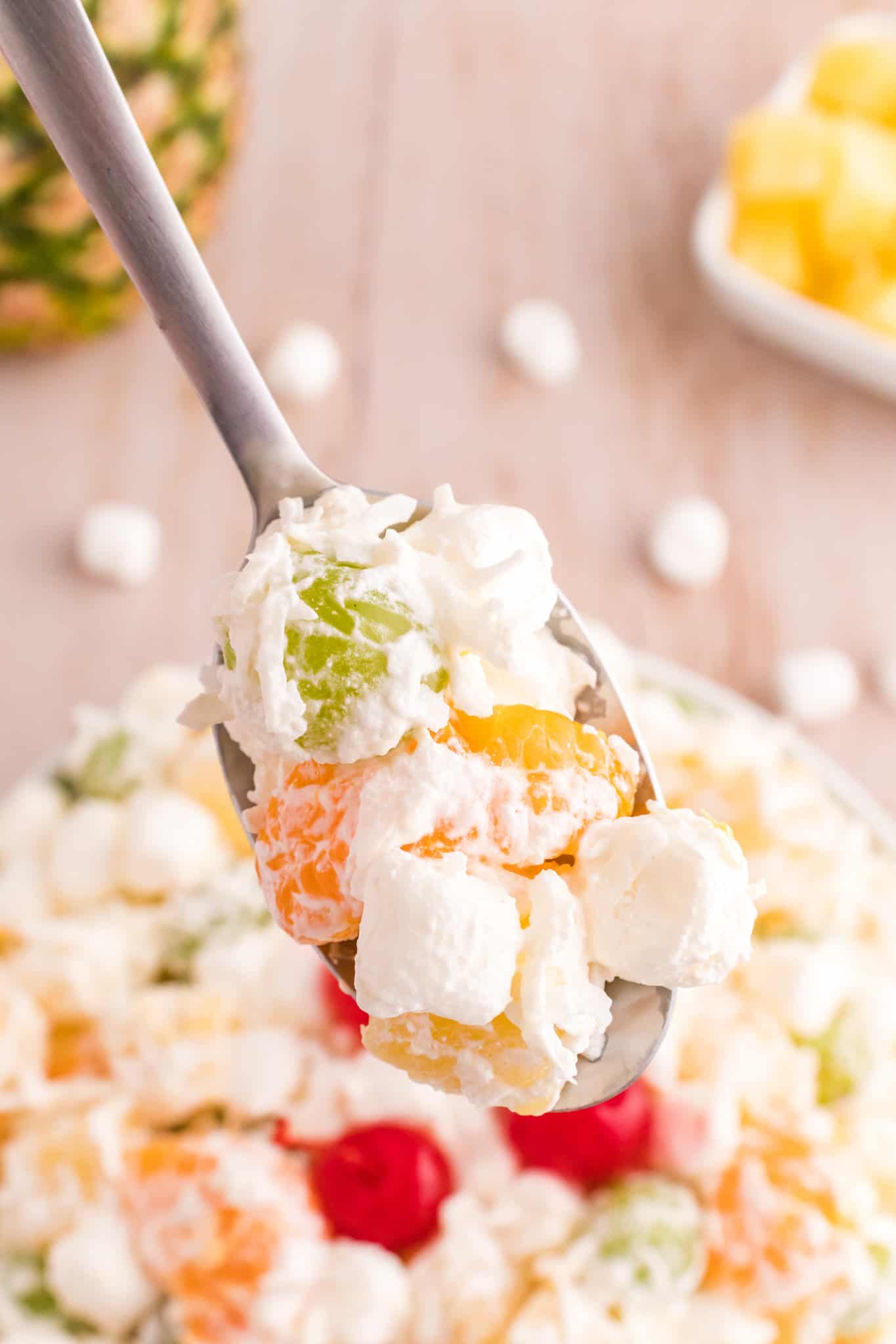 Hawaiian Ambrosia Salad is a sweet and creamy fruit salad recipe loaded with pineapple, mandarins, grapes, shredded coconut, mini marshmallows and Cool Whip.