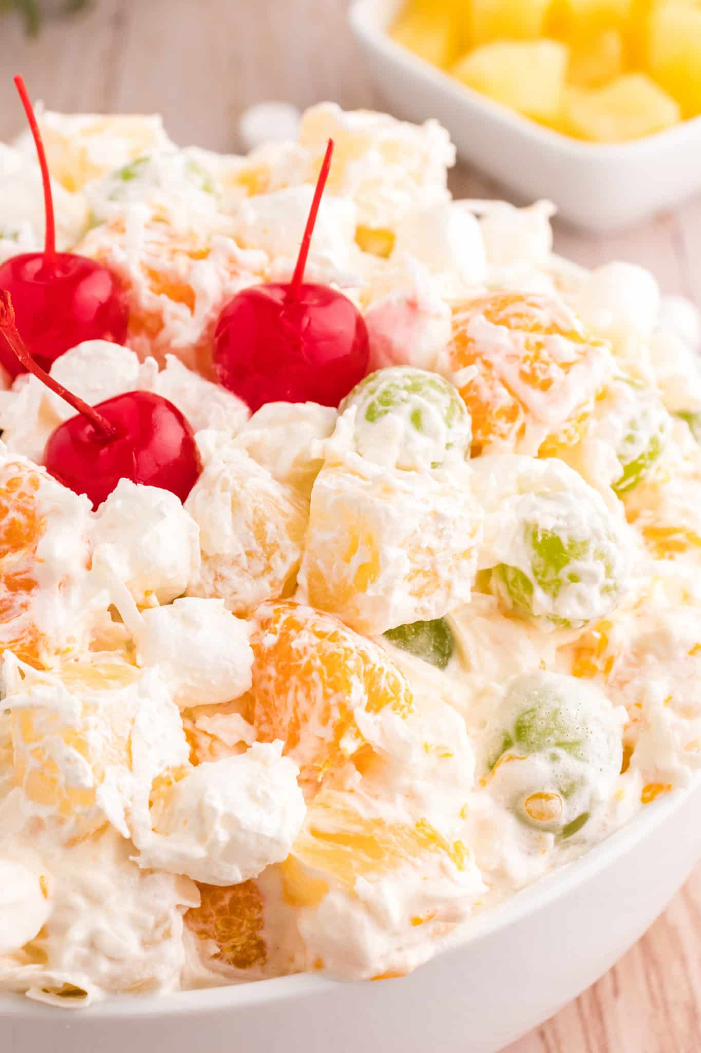 Hawaiian Ambrosia Salad is a sweet and creamy fruit salad recipe loaded with pineapple, mandarins, grapes, shredded coconut, mini marshmallows and Cool Whip.