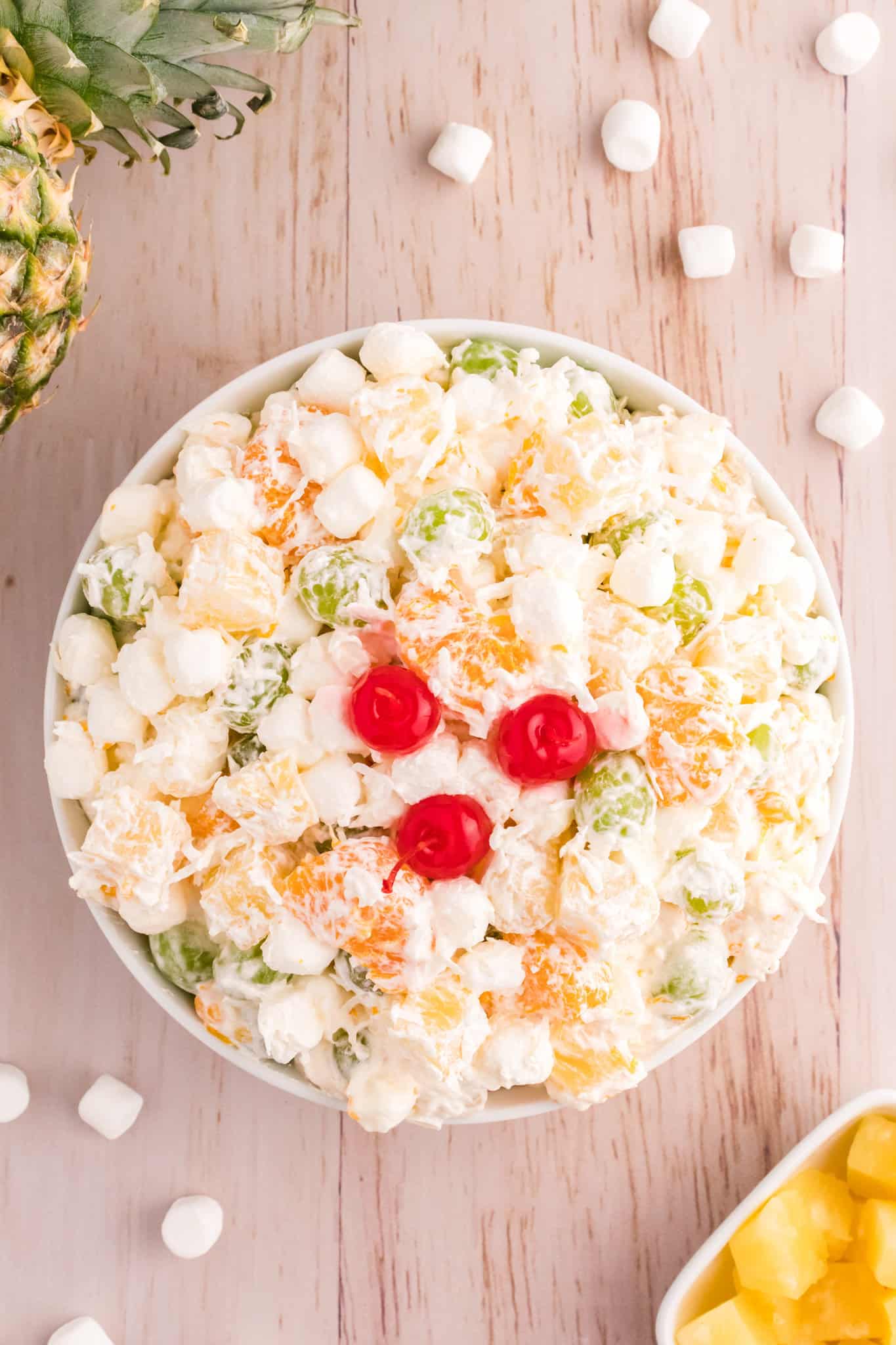 Hawaiian Ambrosia Salad is a sweet and creamy fruit salad recipe loaded with pineapple, mandarins, grapes, shredded coconut, mini marshmallows and Cool Whip.