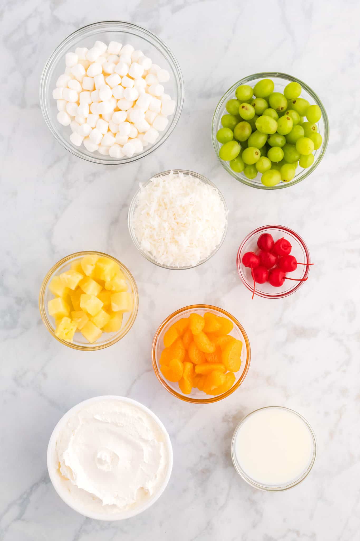 ambrosia salad ingredients in separate prep bowls