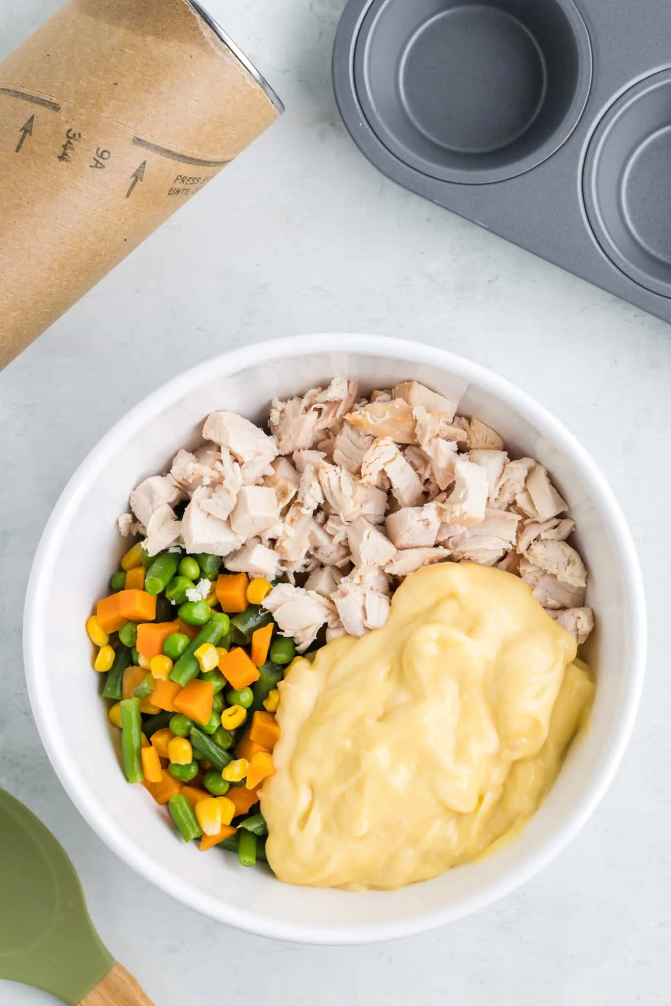 chopped chicken, mixed vegetables and cream of chicken soup in a mixing bowl