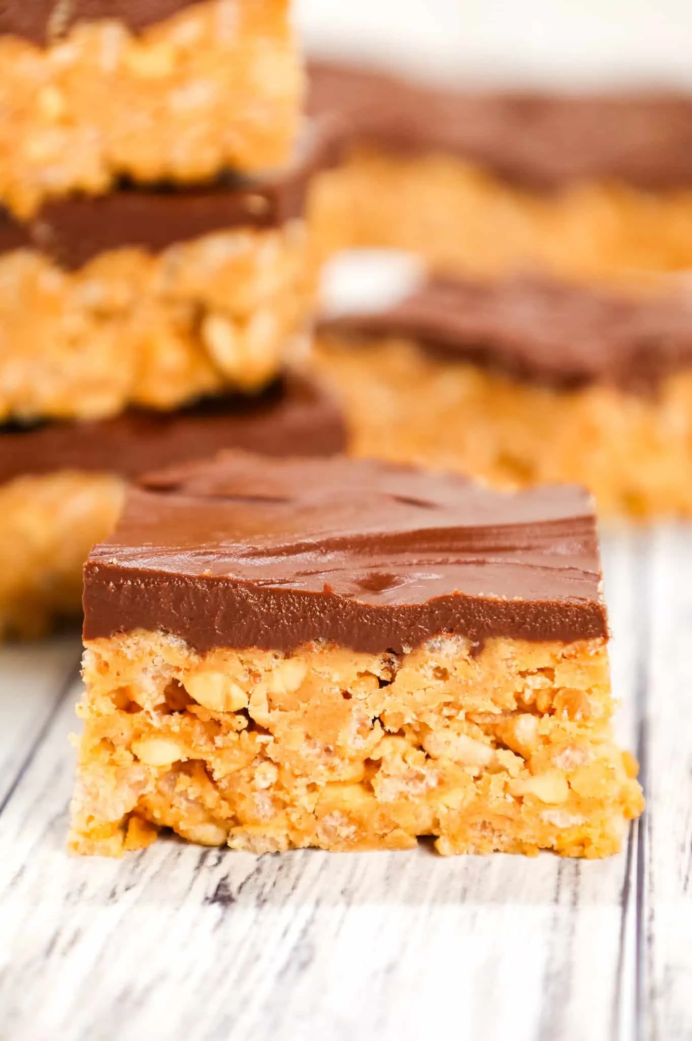 Peanut Butter Crunch Bars are an easy no bake dessert recipe made with base made from crunchy peanut butter, Rice Krispies, corn syrup, peanut butter baking chips and all topped with a layer of chocolate.