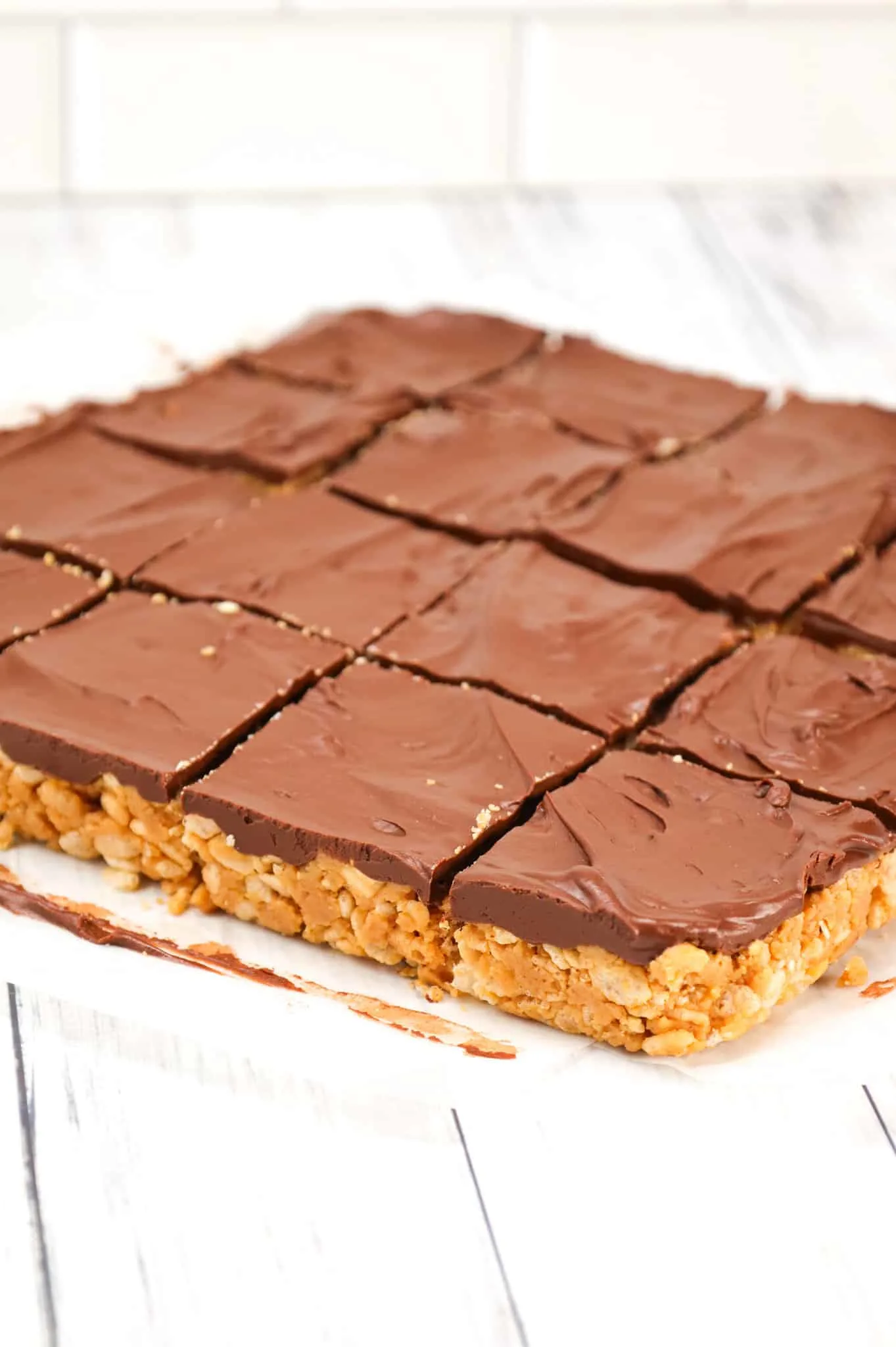 Peanut Butter Crunch Bars are an easy no bake dessert recipe made with base made from crunchy peanut butter, Rice Krispies, corn syrup, peanut butter baking chips and all topped with a layer of chocolate.