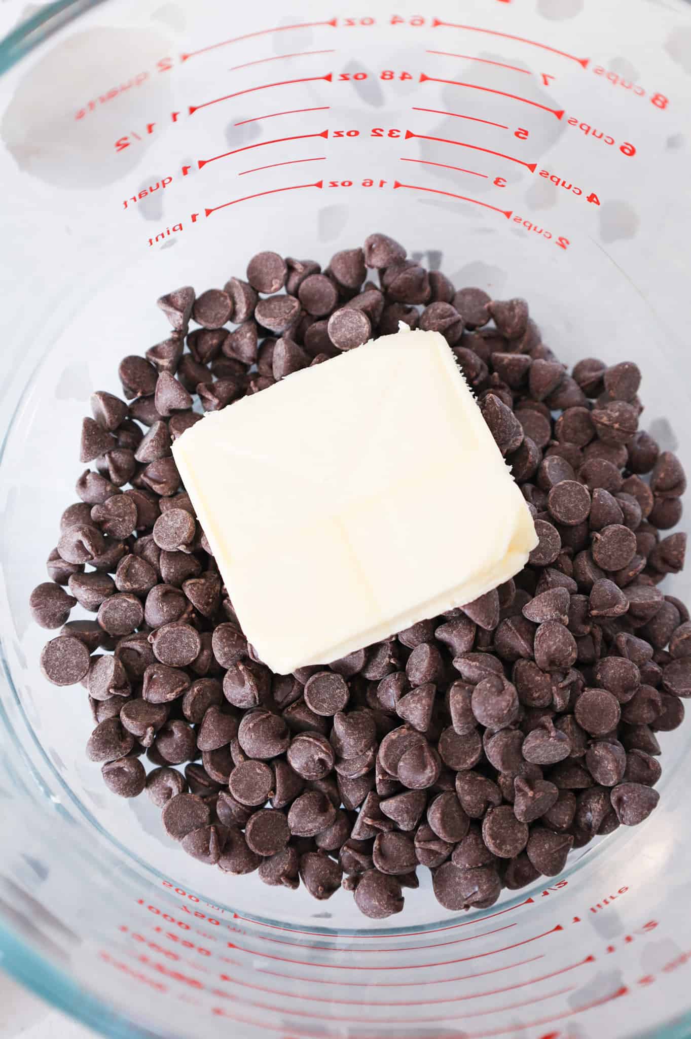 butter and semi sweet chocolate chips in a glass bowl