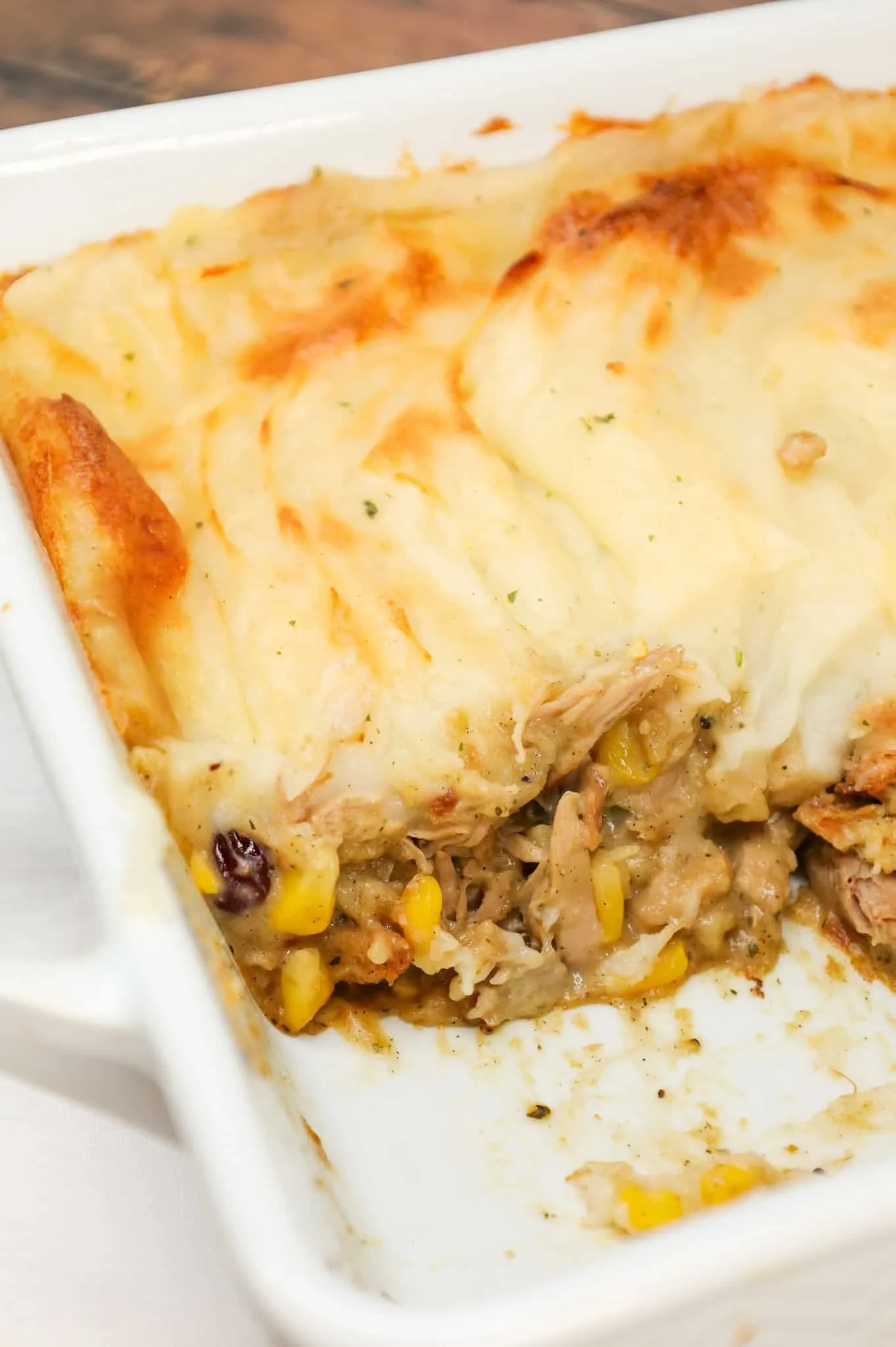 Turkey Shepherd's Pie is a hearty dinner recipe loaded with shredded turkey, corn, Stove Top stuffing mix, cream of chicken soup, cranberries and topped with mashed potatoes.