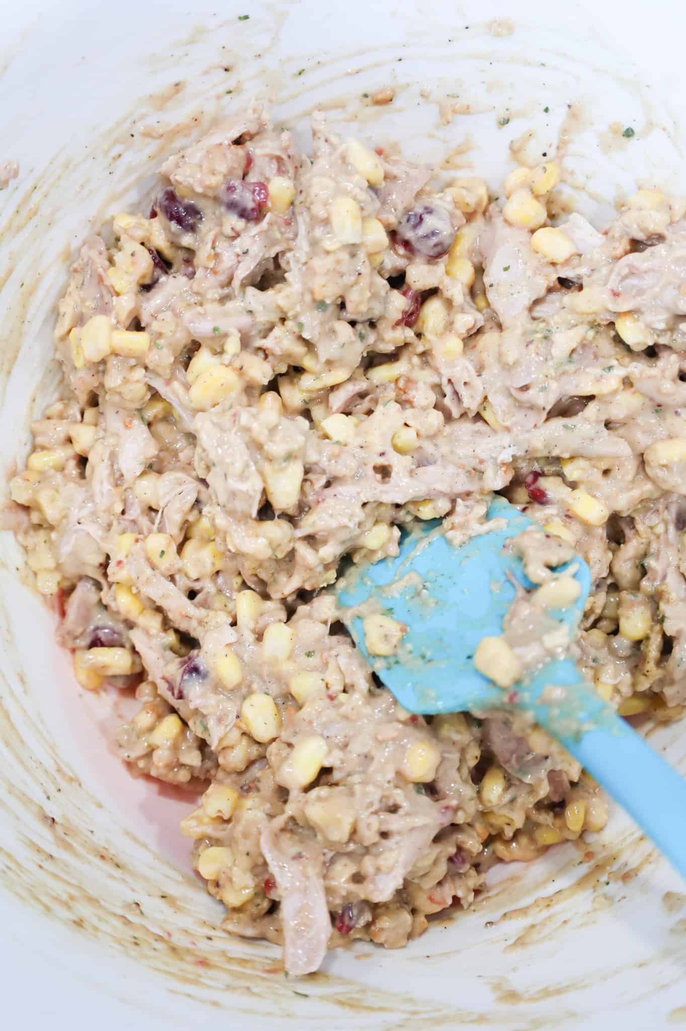 shredded turkey, corn, cranberries, stuffing mix and cream of chicken soup stirred together in a mixing bowl