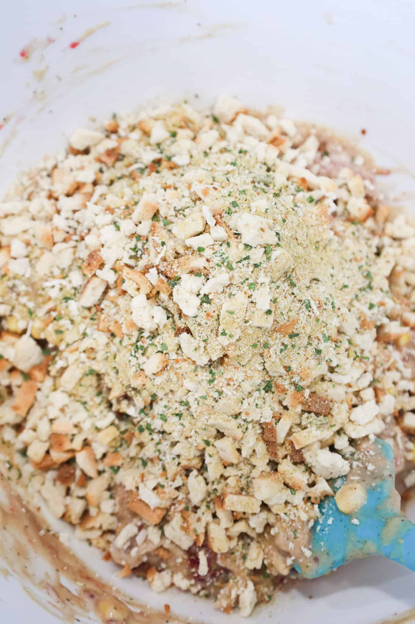 stove top stuffing mix on top of turkey mixture in a mixing bowl