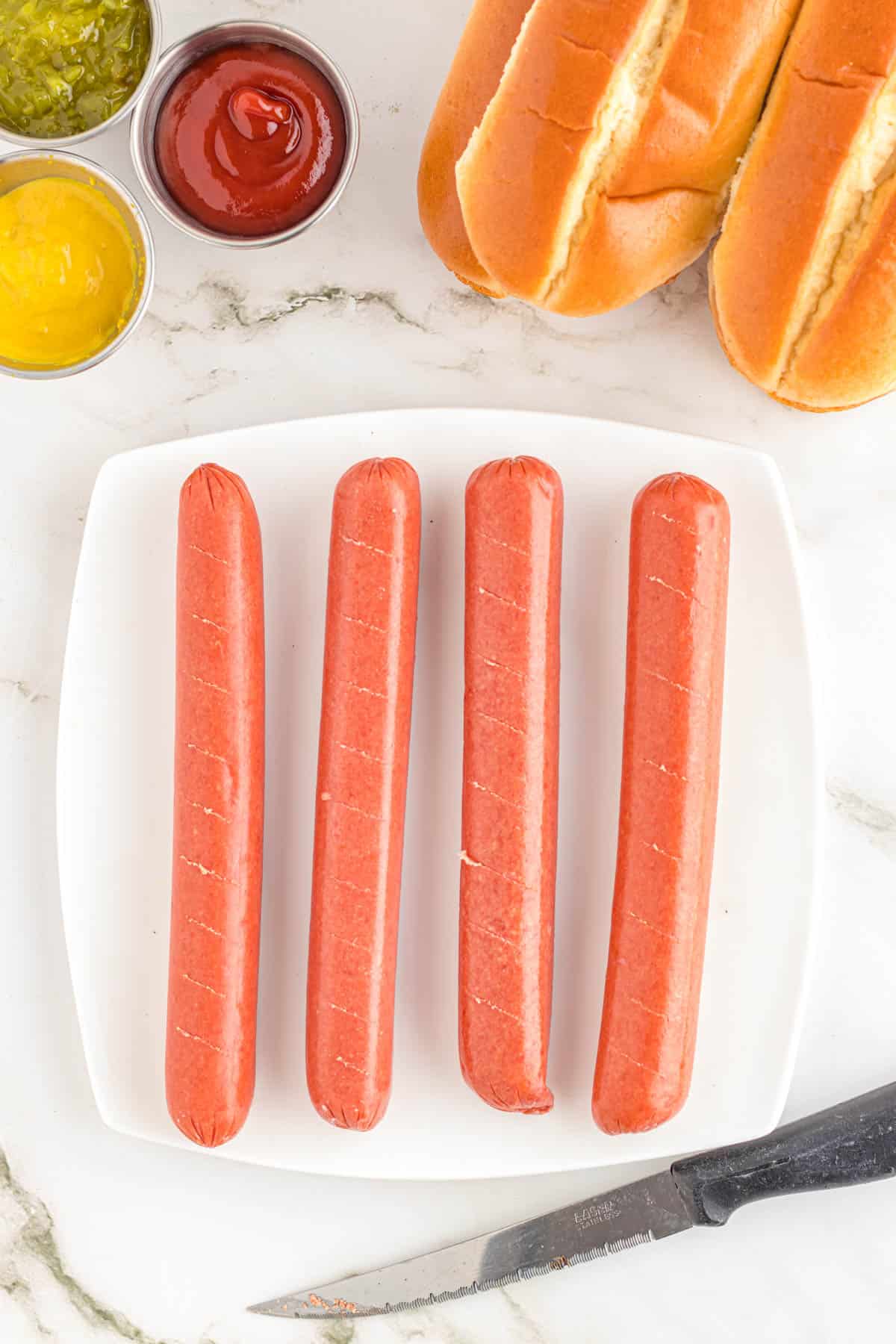 wieners on a plate with slits cut in them
