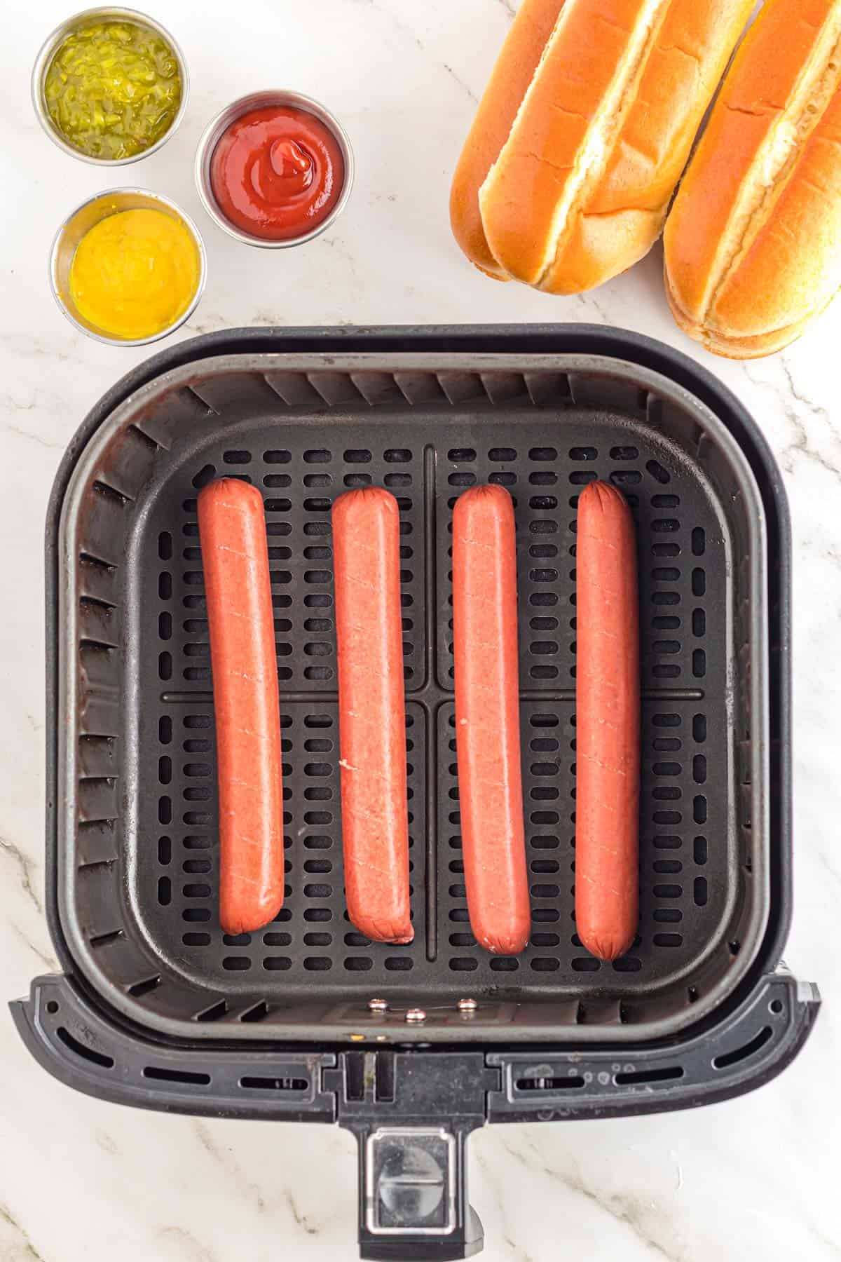 wieners placed in the air fryer basket before cooking