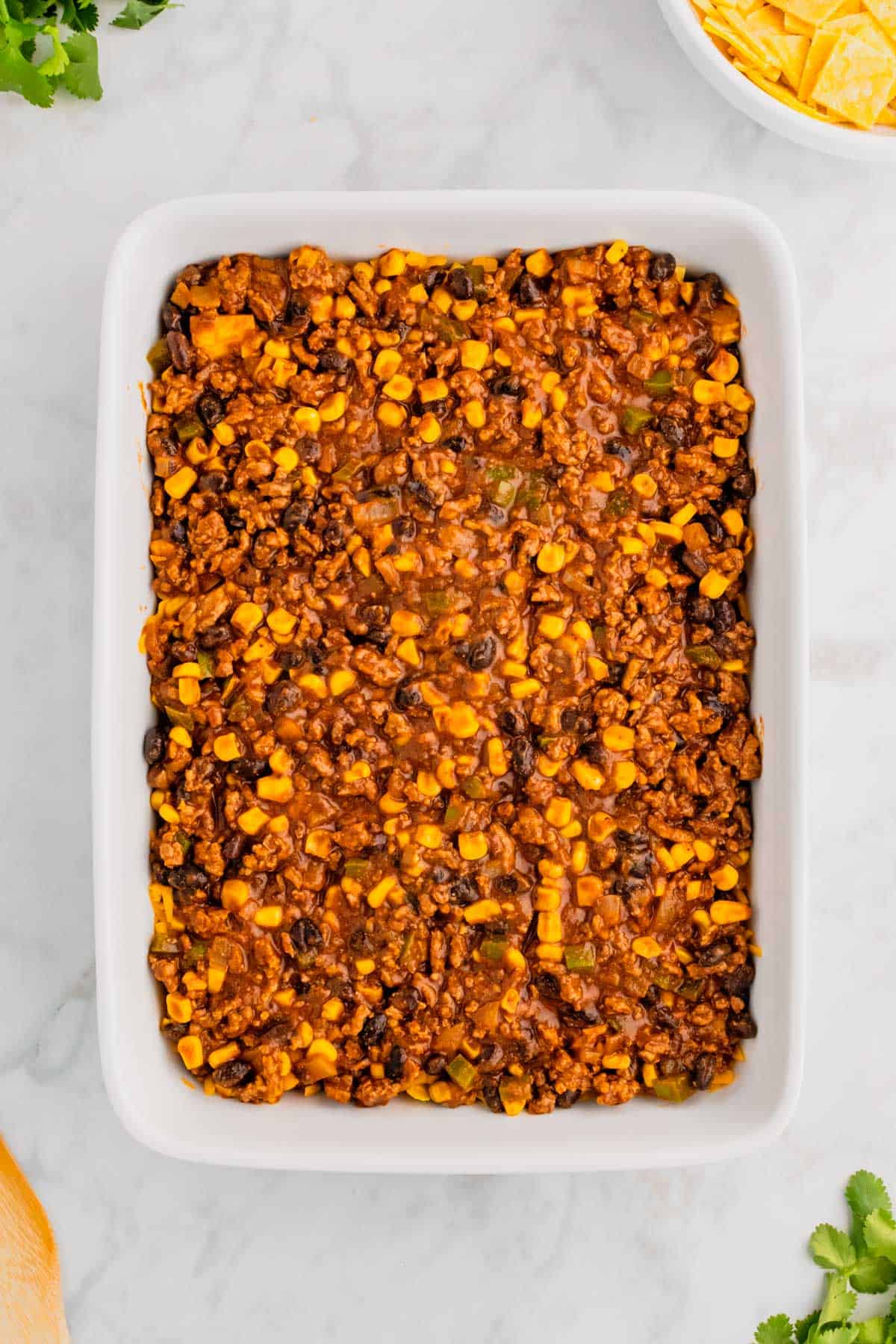 ground beef, bean and corn mixture in a baking dish