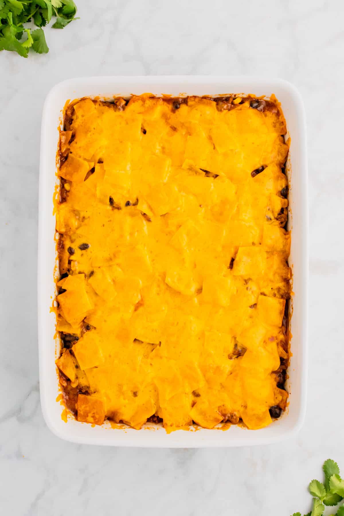 Beef Enchilada Casserole is an easy ground beef casserole recipe loaded with corn, black beans, corn tortillas, enchilada sauce and cheddar cheese.