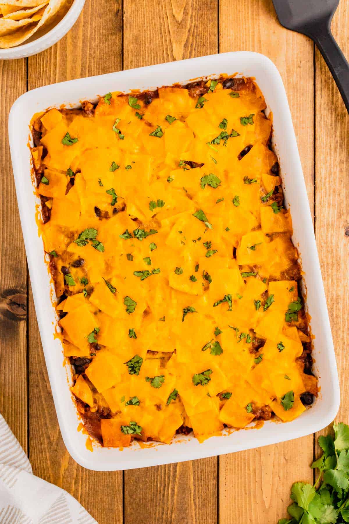 Beef Enchilada Casserole is an easy ground beef casserole recipe loaded with corn, black beans, corn tortillas, enchilada sauce and cheddar cheese.