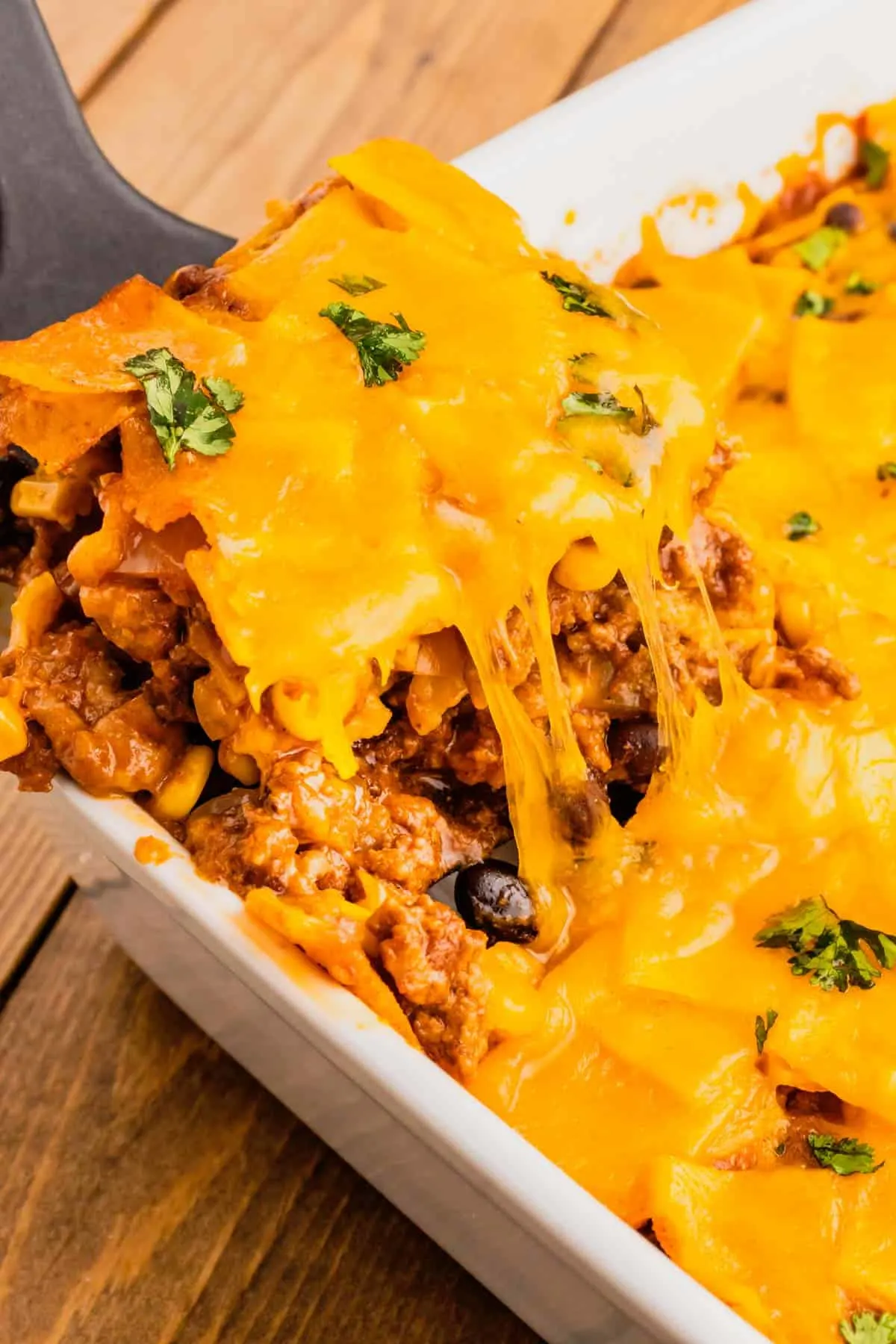 Beef Enchilada Casserole is an easy ground beef casserole recipe loaded with corn, black beans, corn tortillas, enchilada sauce and cheddar cheese.