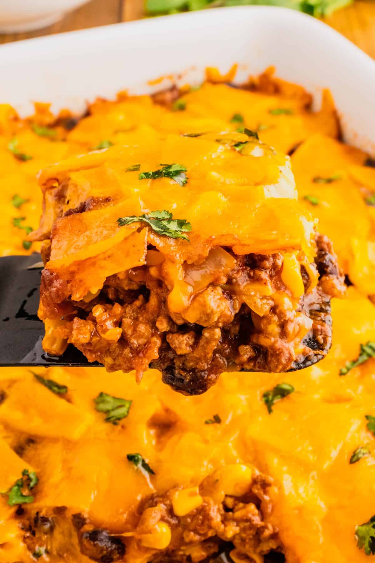 Beef Enchilada Casserole is an easy ground beef casserole recipe loaded with corn, black beans, corn tortillas, enchilada sauce and cheddar cheese.