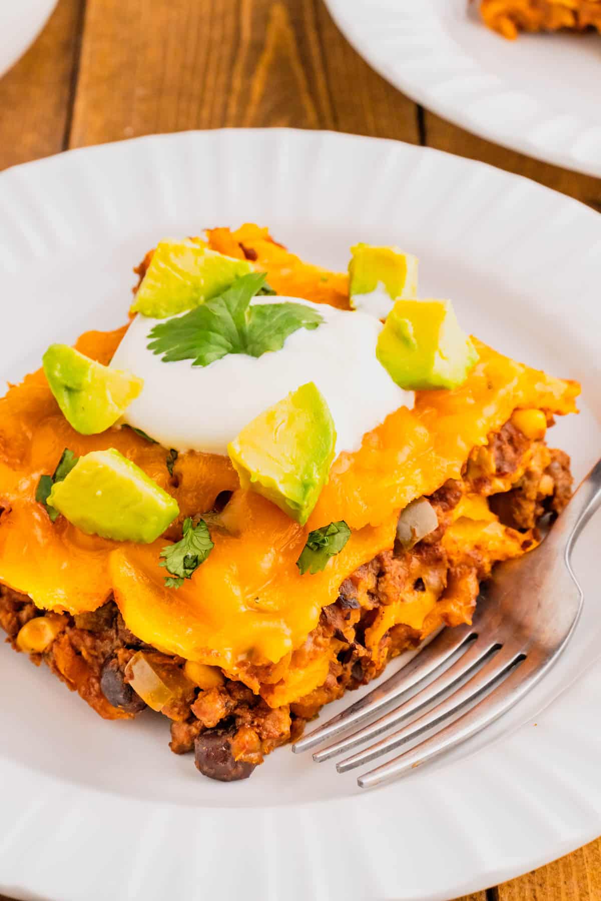 Beef Enchilada Casserole is an easy ground beef casserole recipe loaded with corn, black beans, corn tortillas, enchilada sauce and cheddar cheese.