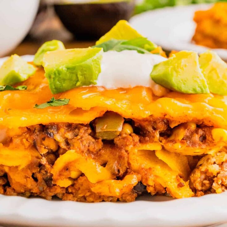 Beef Enchilada Casserole is an easy ground beef casserole recipe loaded with corn, black beans, corn tortillas, enchilada sauce and cheddar cheese.