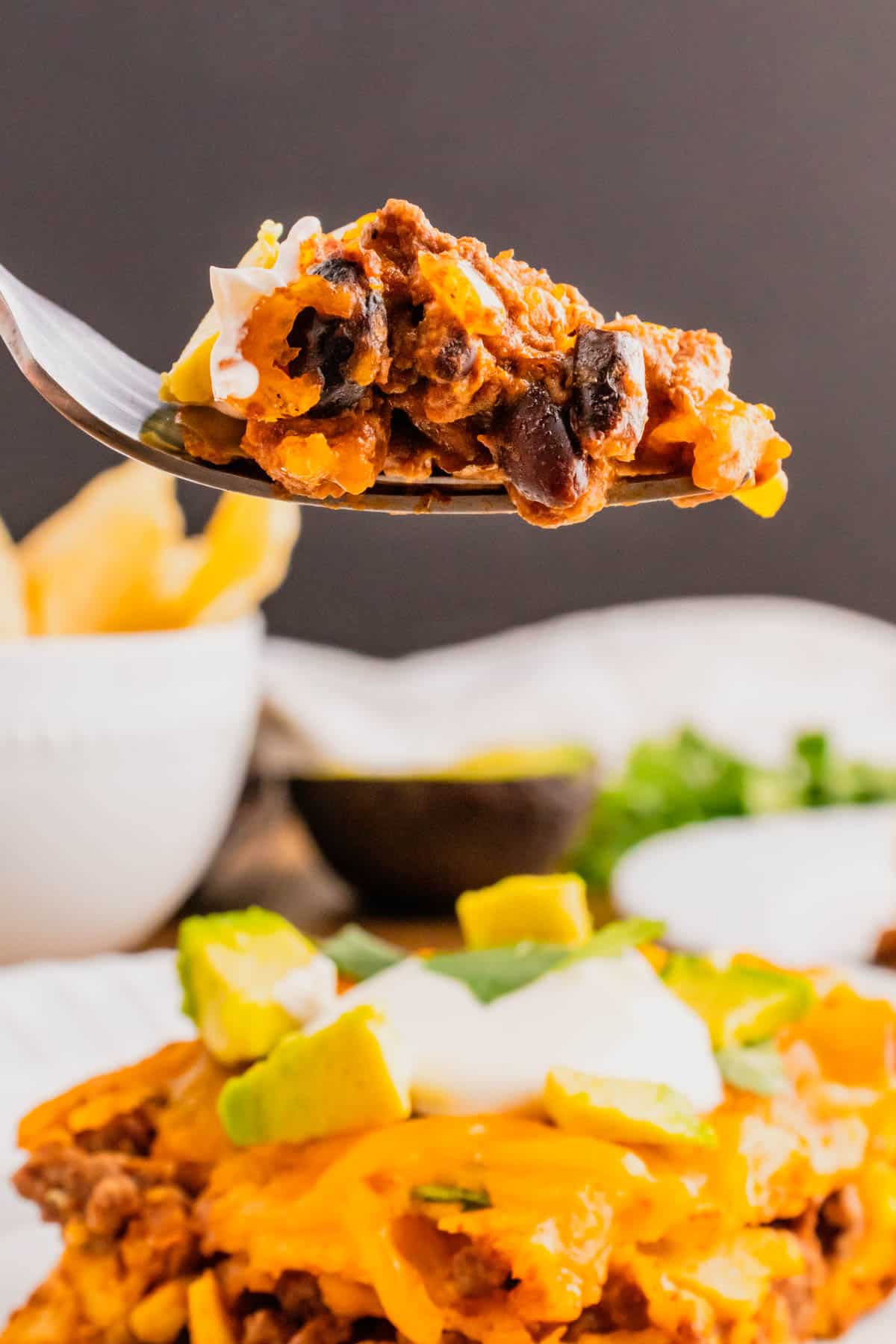 Beef Enchilada Casserole is an easy ground beef casserole recipe loaded with corn, black beans, corn tortillas, enchilada sauce and cheddar cheese.