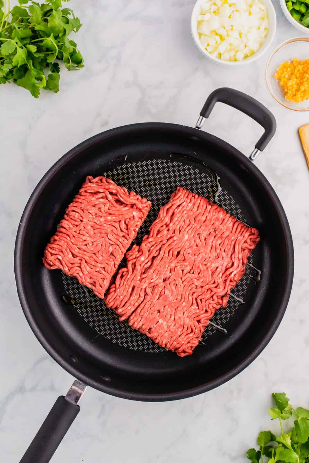 raw ground beef in a skillet