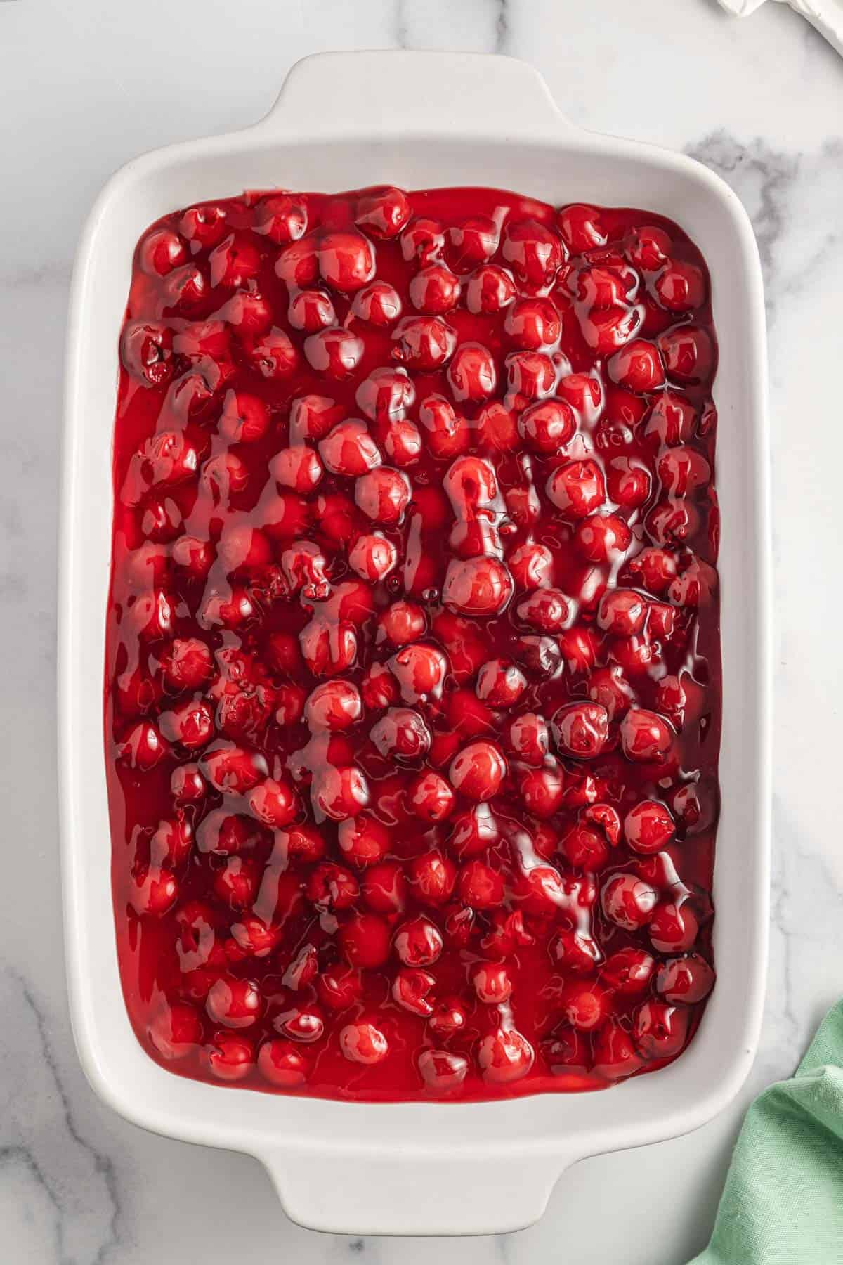 Cherry Delight is an easy no bake dessert with a graham crumb base, cream cheese and Cool Whip filling and topped with canned cherry pie filling.