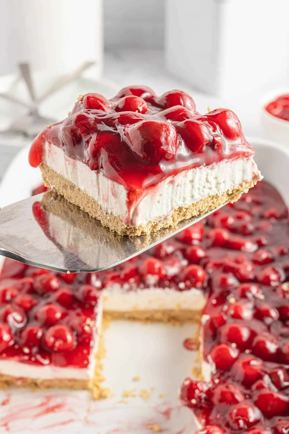 Cherry Delight is an easy no bake dessert with a graham crumb base, cream cheese and Cool Whip filling and topped with canned cherry pie filling.