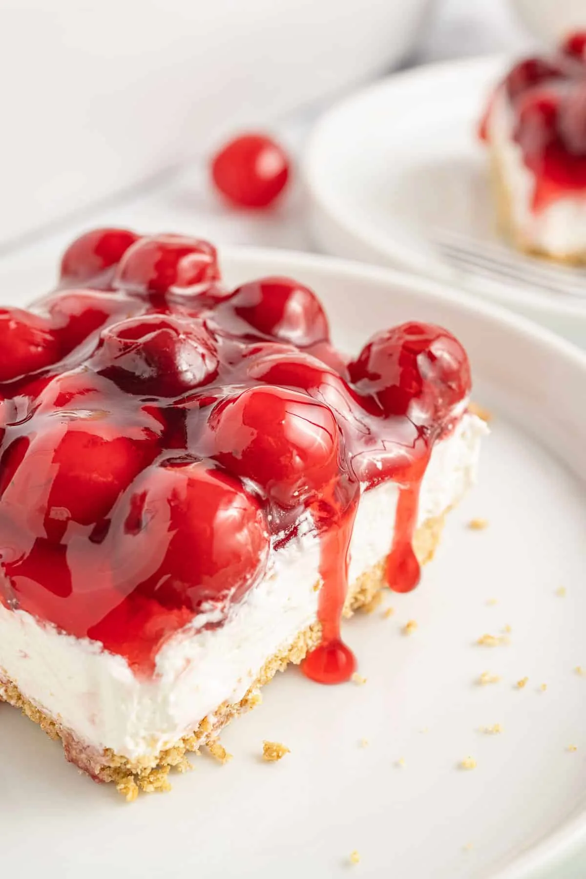 Cherry Delight is an easy no bake dessert with a graham crumb base, cream cheese and Cool Whip filling and topped with canned cherry pie filling.