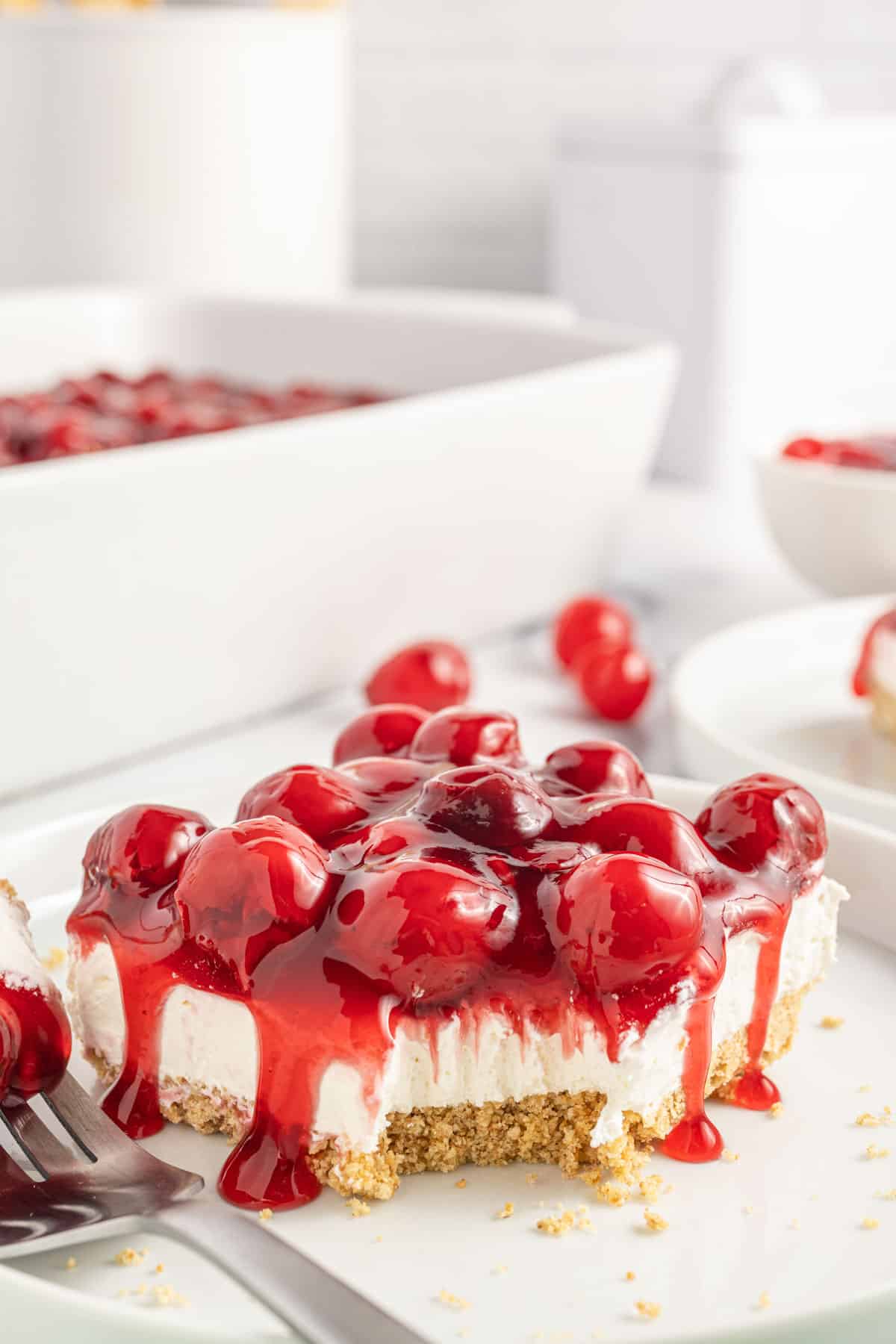 Cherry Delight is an easy no bake dessert with a graham crumb base, cream cheese and Cool Whip filling and topped with canned cherry pie filling.