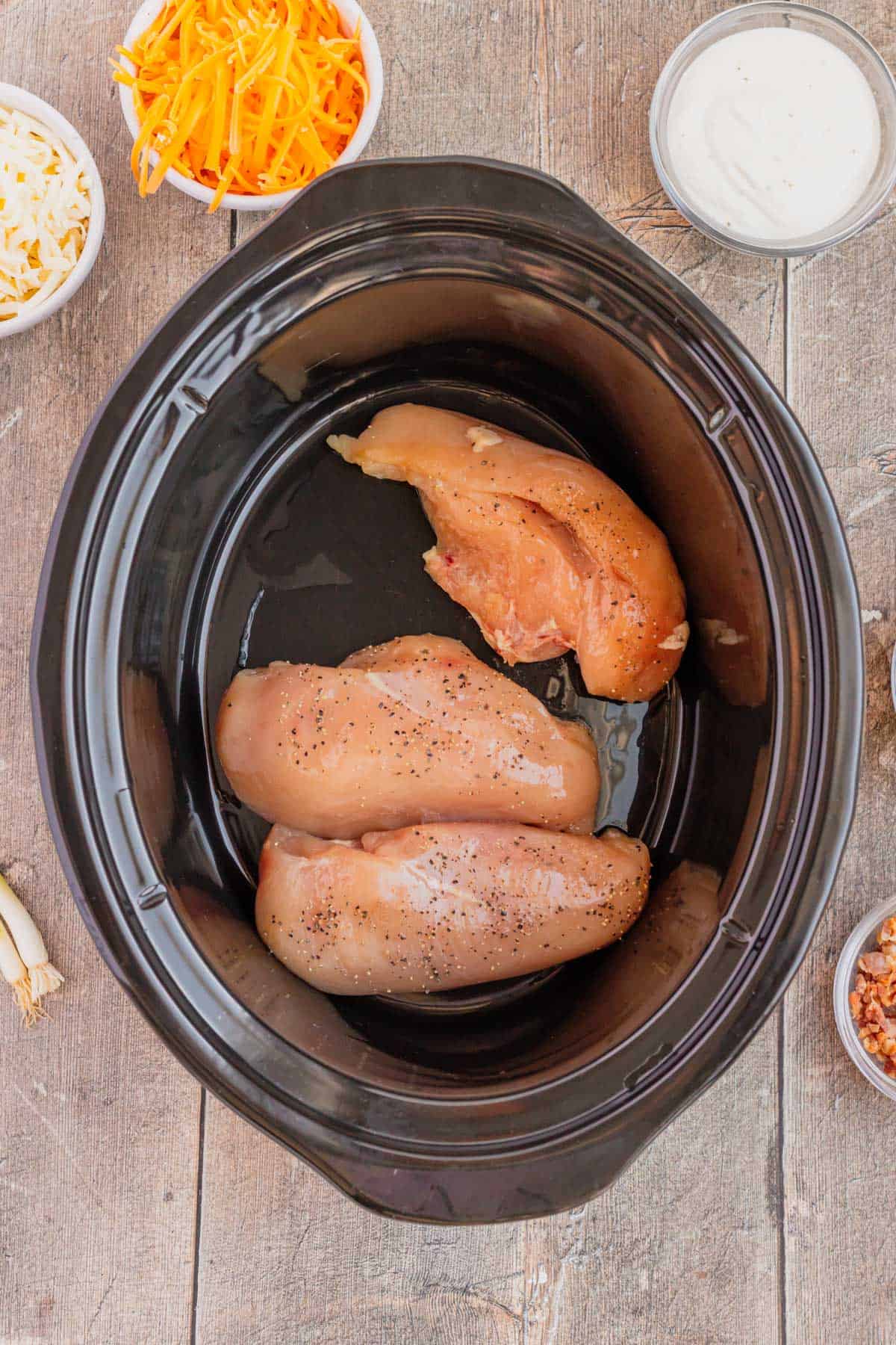 raw boneless skinless chicken breasts in a crock pot