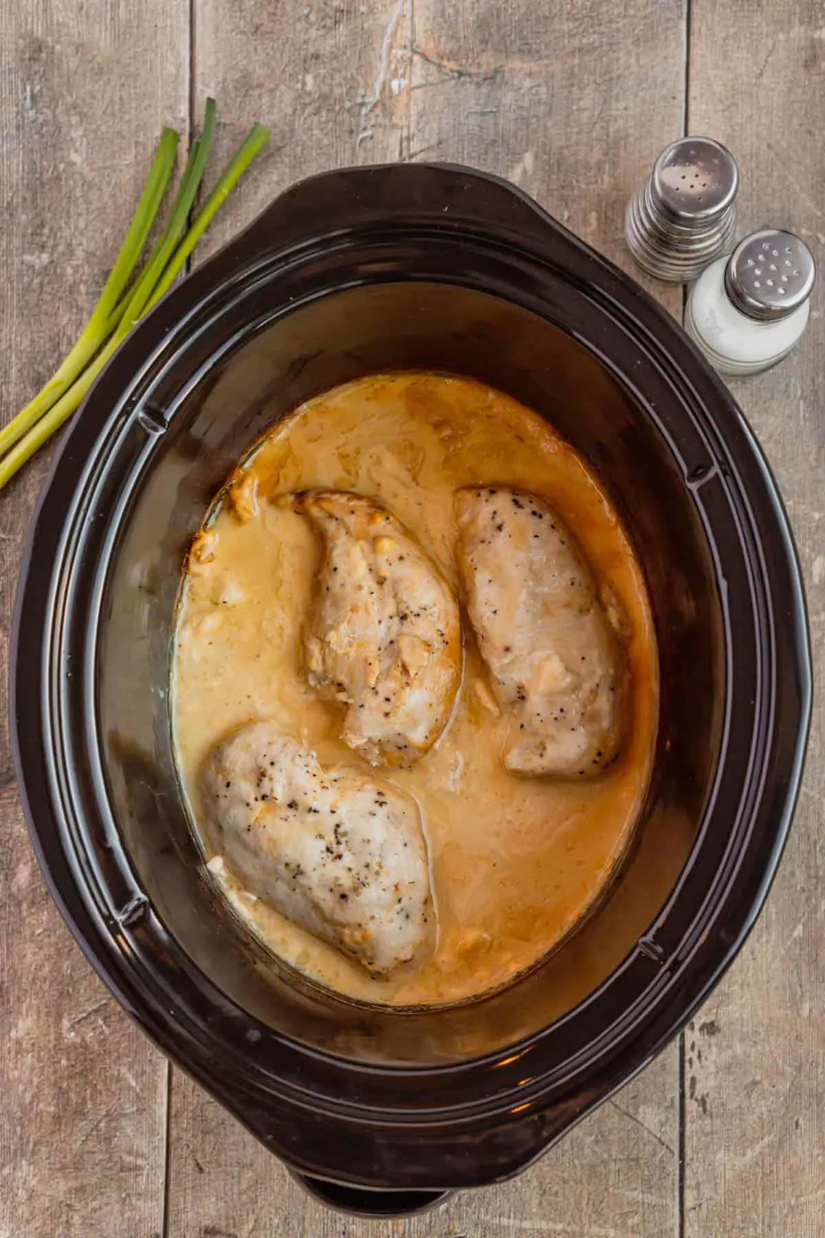 cooked chicken breasts in a slow cooker