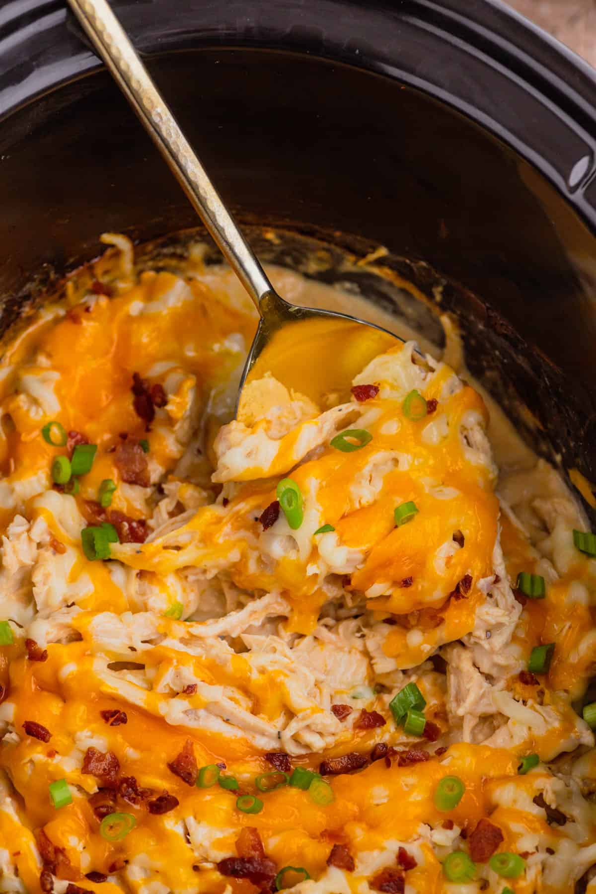 Crock Pot Crack Chicken is a creamy slow cooker chicken dish loaded with ranch dressing, shredded chicken, cream cheese, bacon, shredded cheese and chopped green onions.