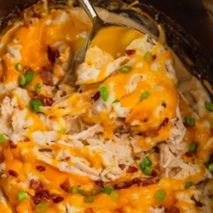 Crock Pot Crack Chicken is a creamy slow cooker chicken dish loaded with ranch dressing, shredded chicken, cream cheese, bacon, shredded cheese and chopped green onions.