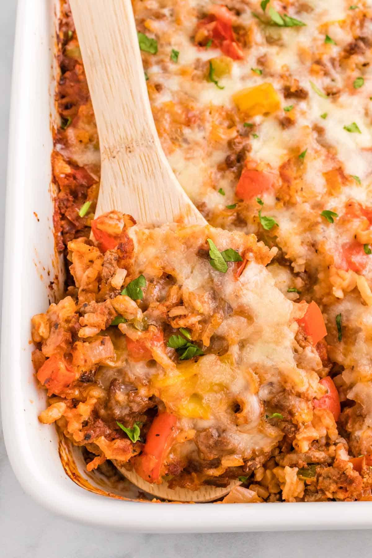 Stuffed Pepper Casserole is a hearty ground beef casserole loaded with diced bell peppers, white rice, diced tomatoes, tomato sauce and baked with mozzarella cheese on top.