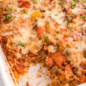 Stuffed Pepper Casserole is a hearty ground beef casserole loaded with diced bell peppers, white rice, diced tomatoes, tomato sauce and baked with mozzarella cheese on top.