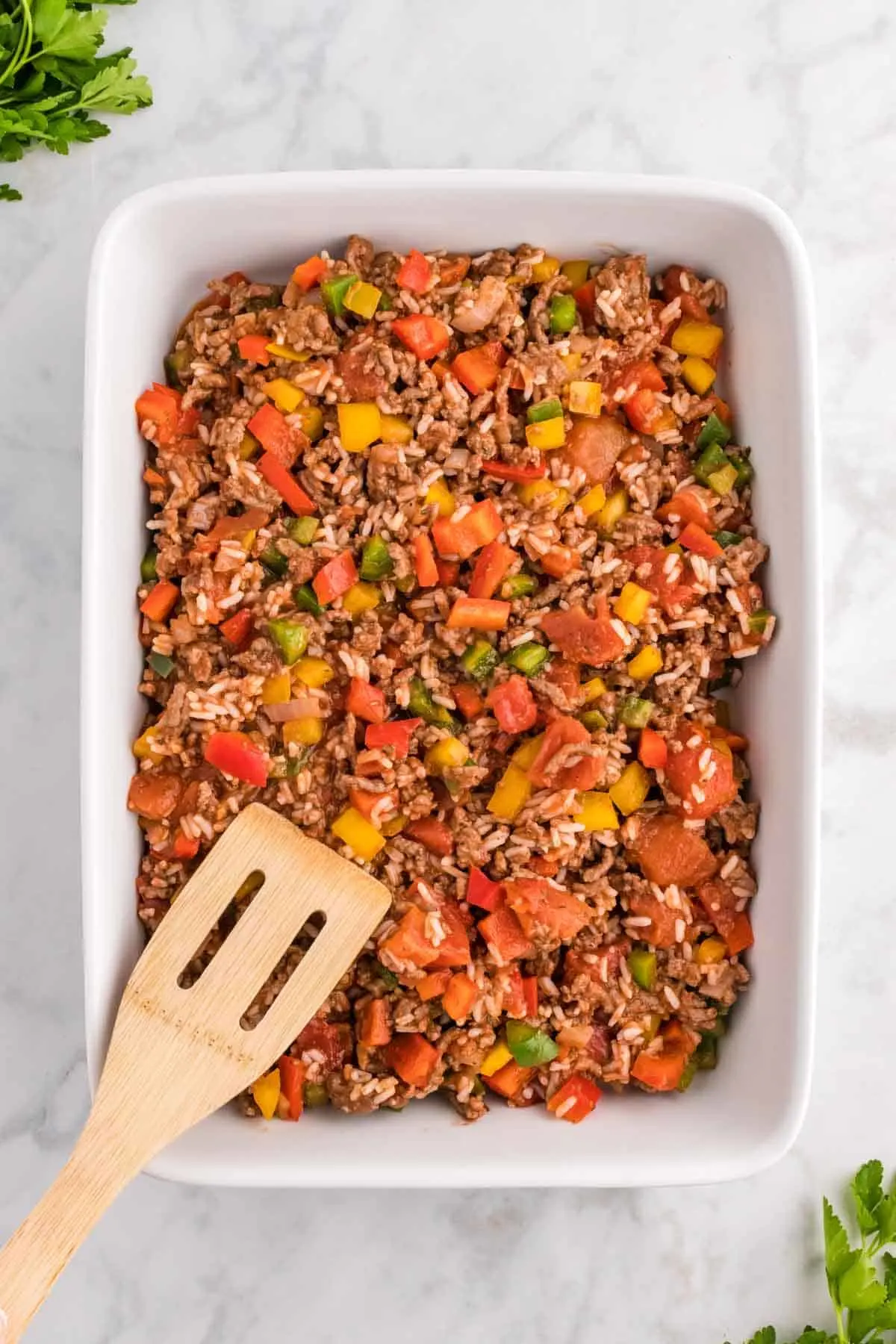 ground beef and diced pepper mixture in a baking dish