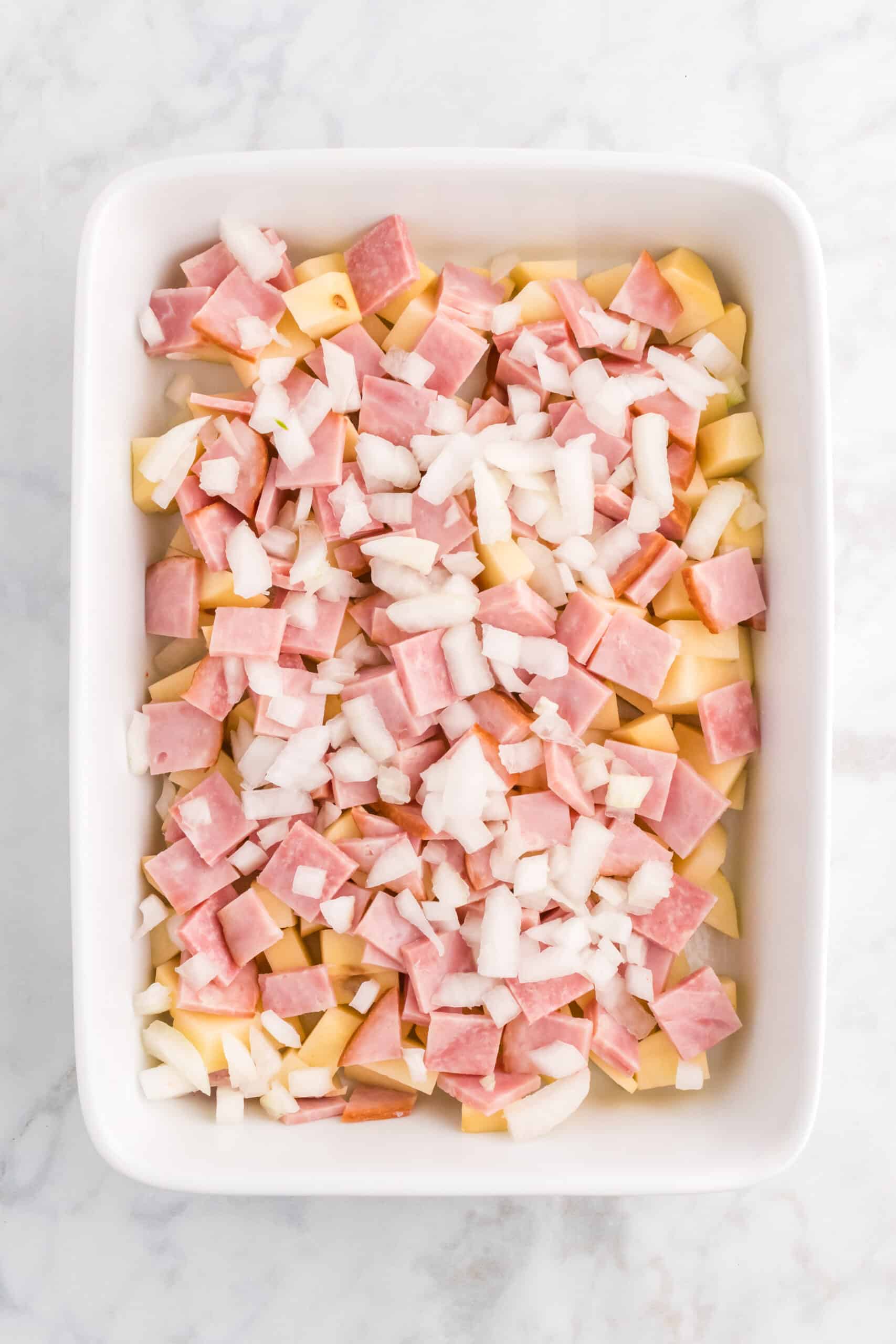 diced ham, potatoes and onions in a baking dish