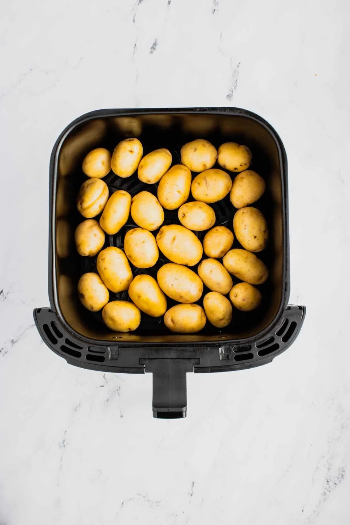 baby gold potatoes in an air fryer basket