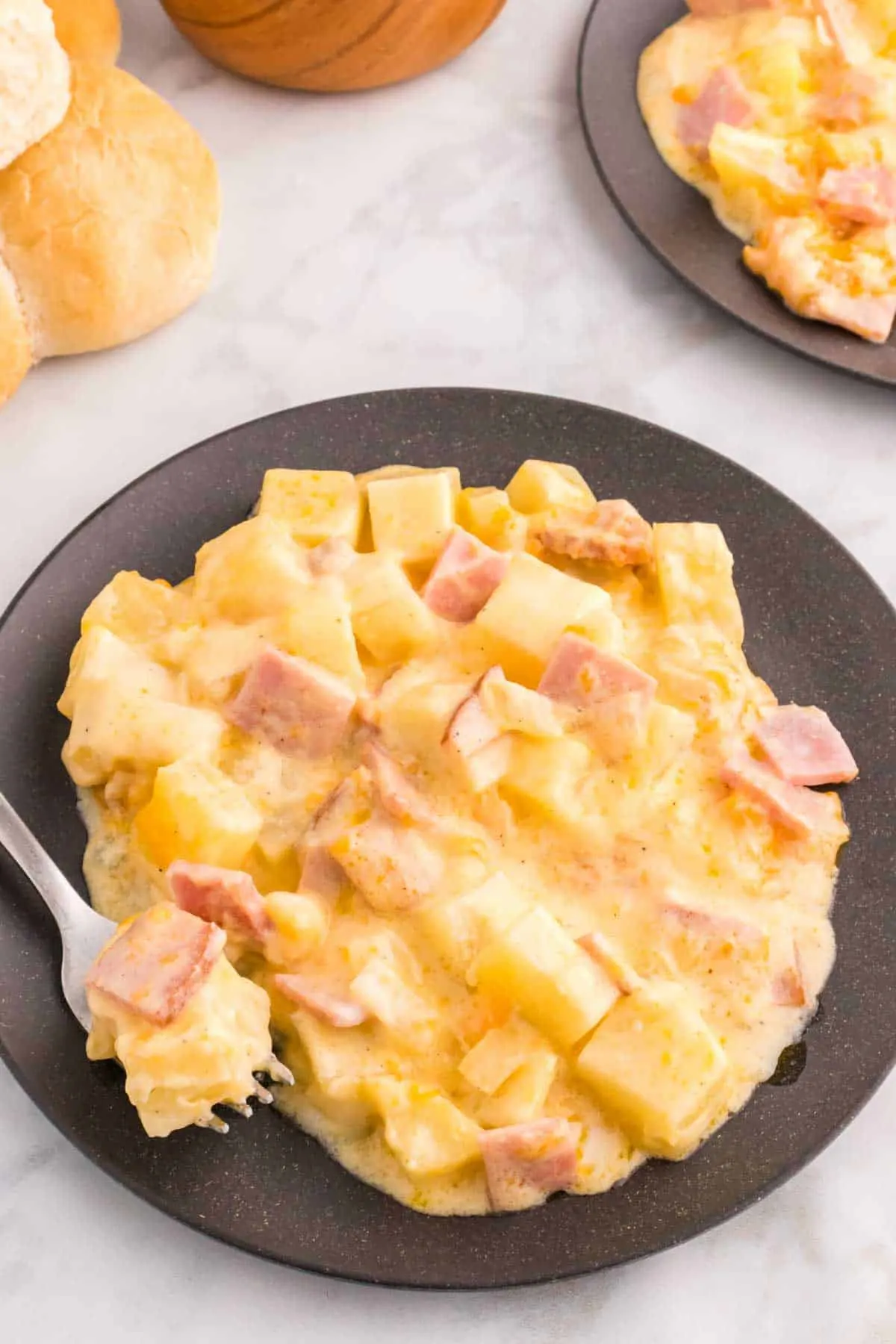 Cheesy Ham and Potato Casserole is a hearty dish loaded with diced potatoes, ham and onions all covered in a creamy sauce and baked with cheddar cheese on top.