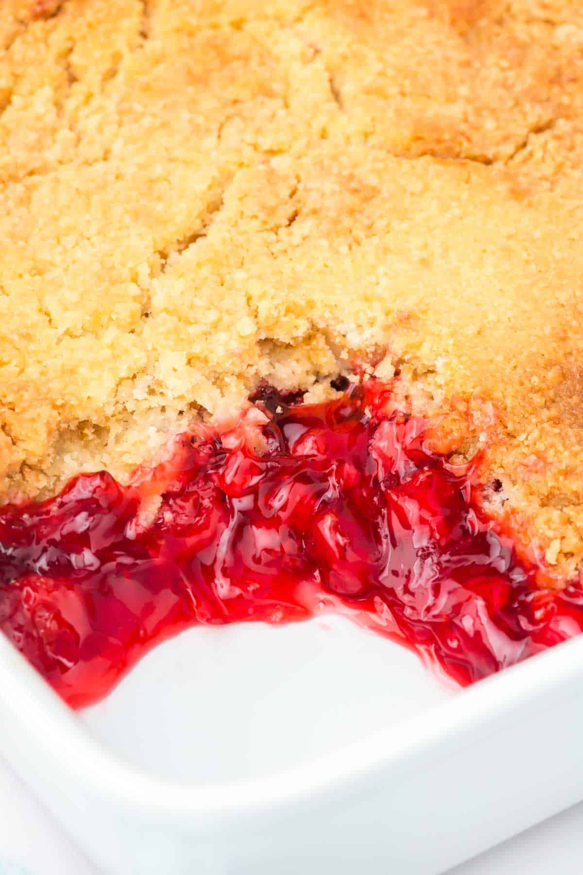 Cherry Dump Cake is an easy dessert recipe made with cherry pie filling, vanilla cake mix, crumbled butter cookies, vanilla extract and butter.