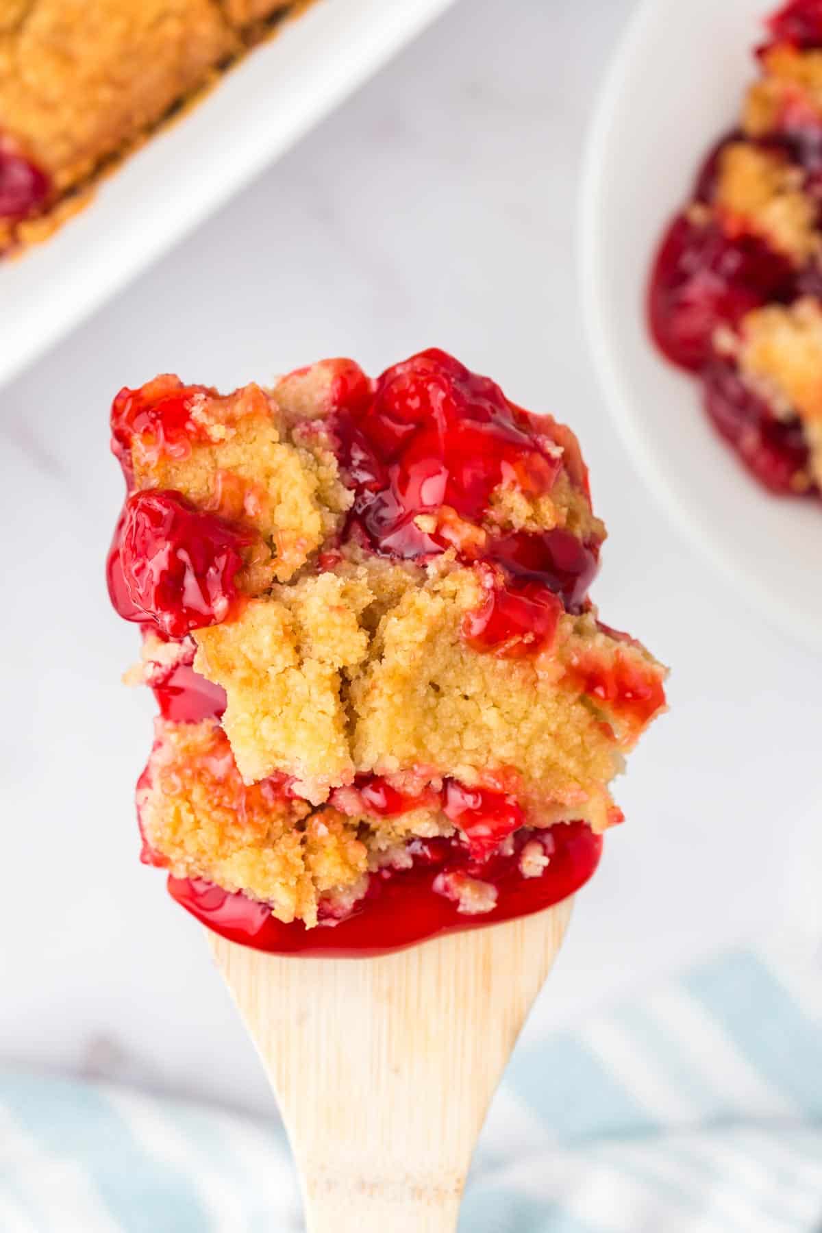 Cherry Dump Cake is an easy dessert recipe made with cherry pie filling, vanilla cake mix, crumbled butter cookies, vanilla extract and butter.