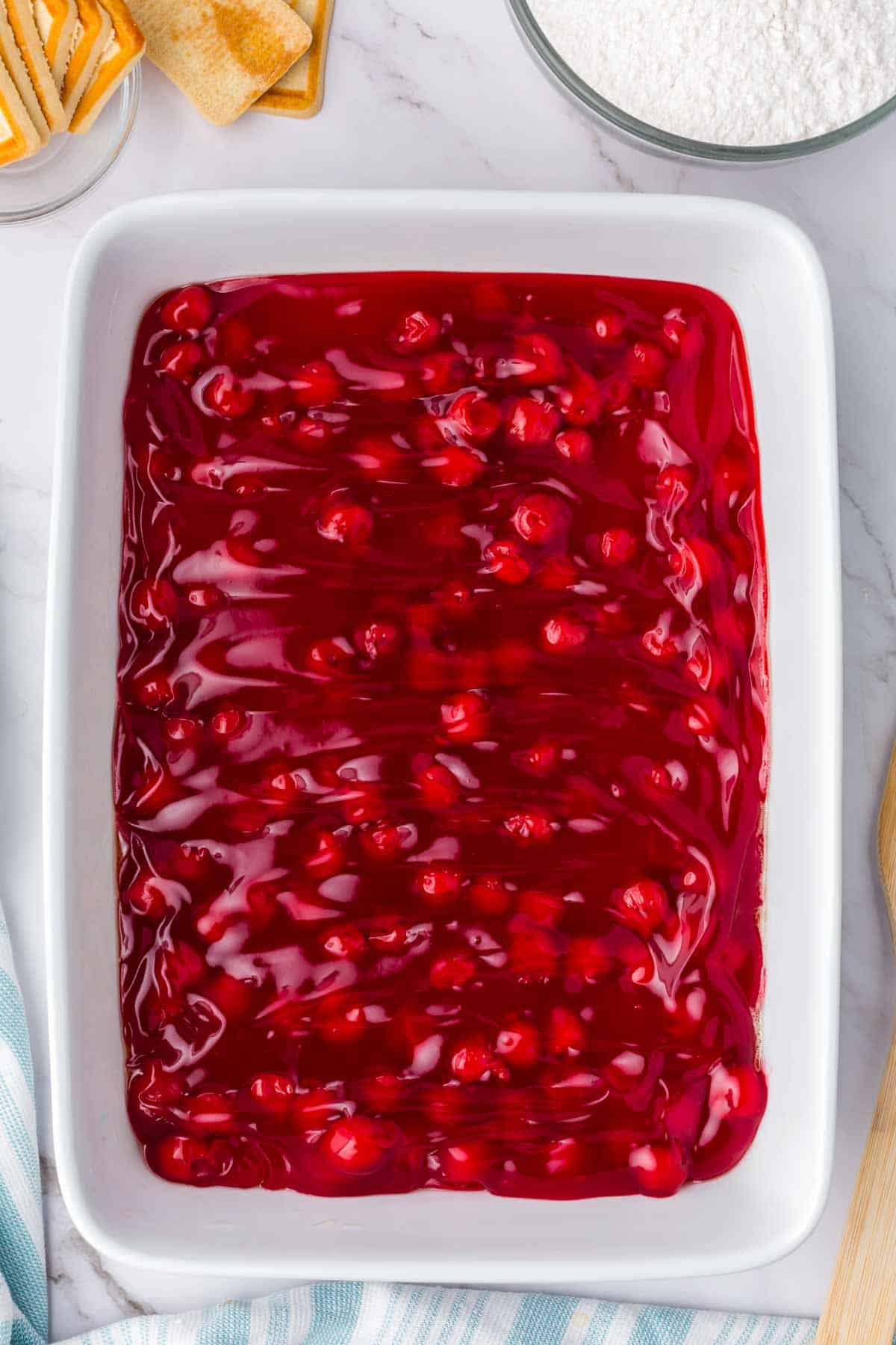 canned cherry pie filling in the bottom of a baking dish