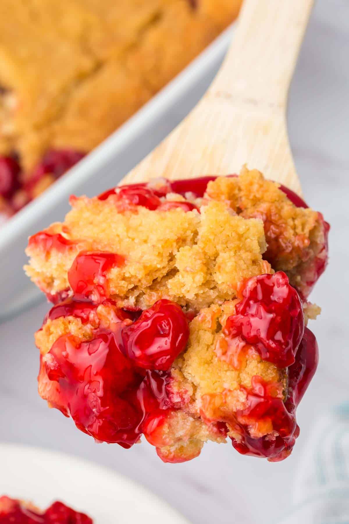 Cherry Dump Cake is an easy dessert recipe made with cherry pie filling, vanilla cake mix, crumbled butter cookies, vanilla extract and butter.