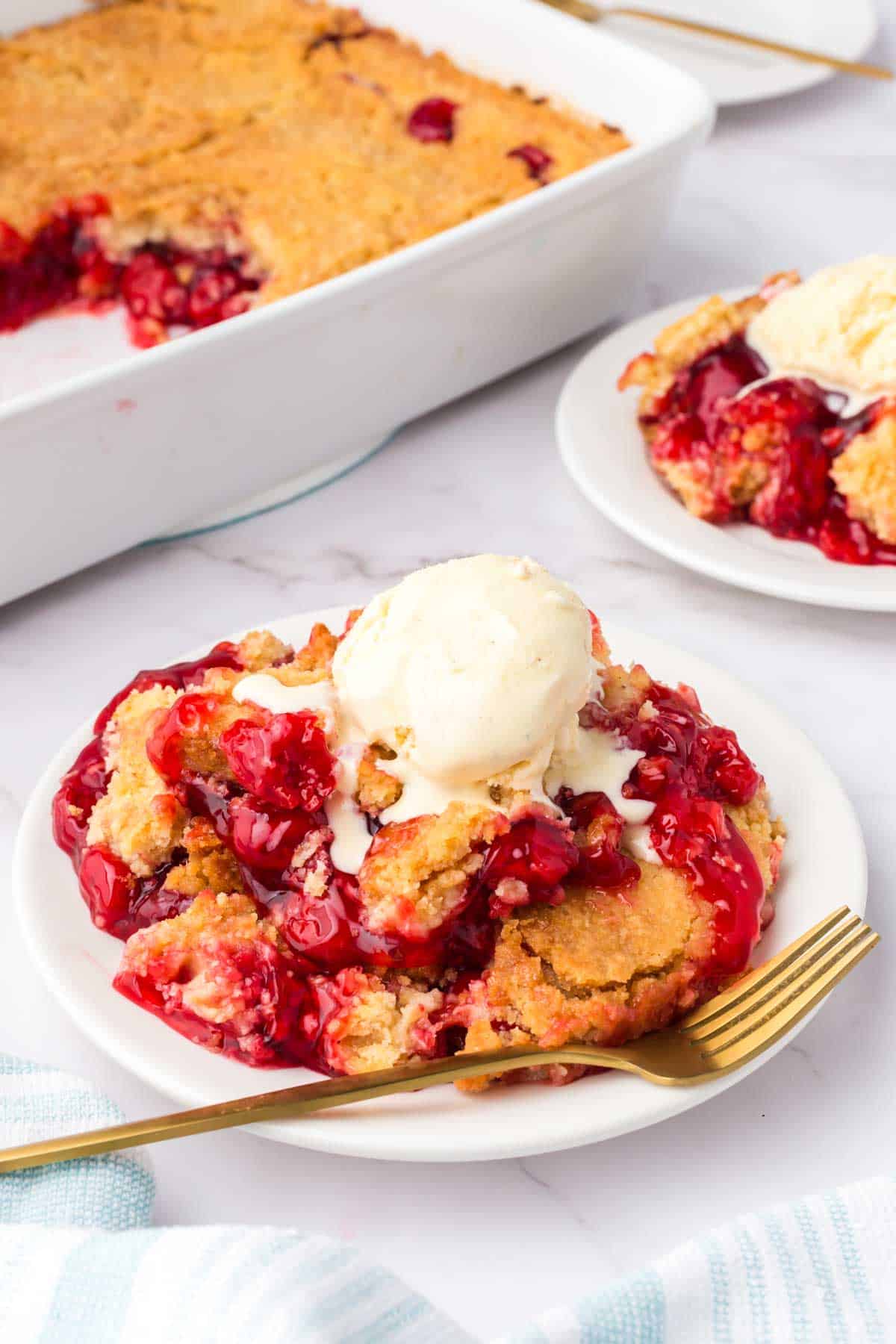 Cherry Dump Cake is an easy dessert recipe made with cherry pie filling, vanilla cake mix, crumbled butter cookies, vanilla extract and butter.