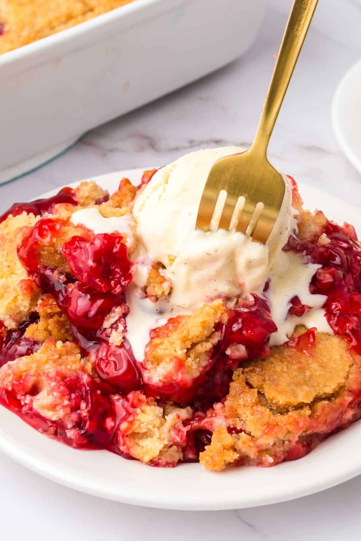 Cherry Dump Cake is an easy dessert recipe made with cherry pie filling, vanilla cake mix, crumbled butter cookies, vanilla extract and butter.