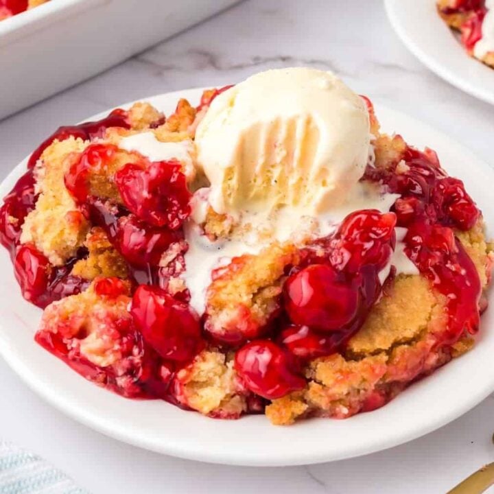 Cherry Dump Cake is an easy dessert recipe made with cherry pie filling, vanilla cake mix, crumbled butter cookies, vanilla extract and butter.