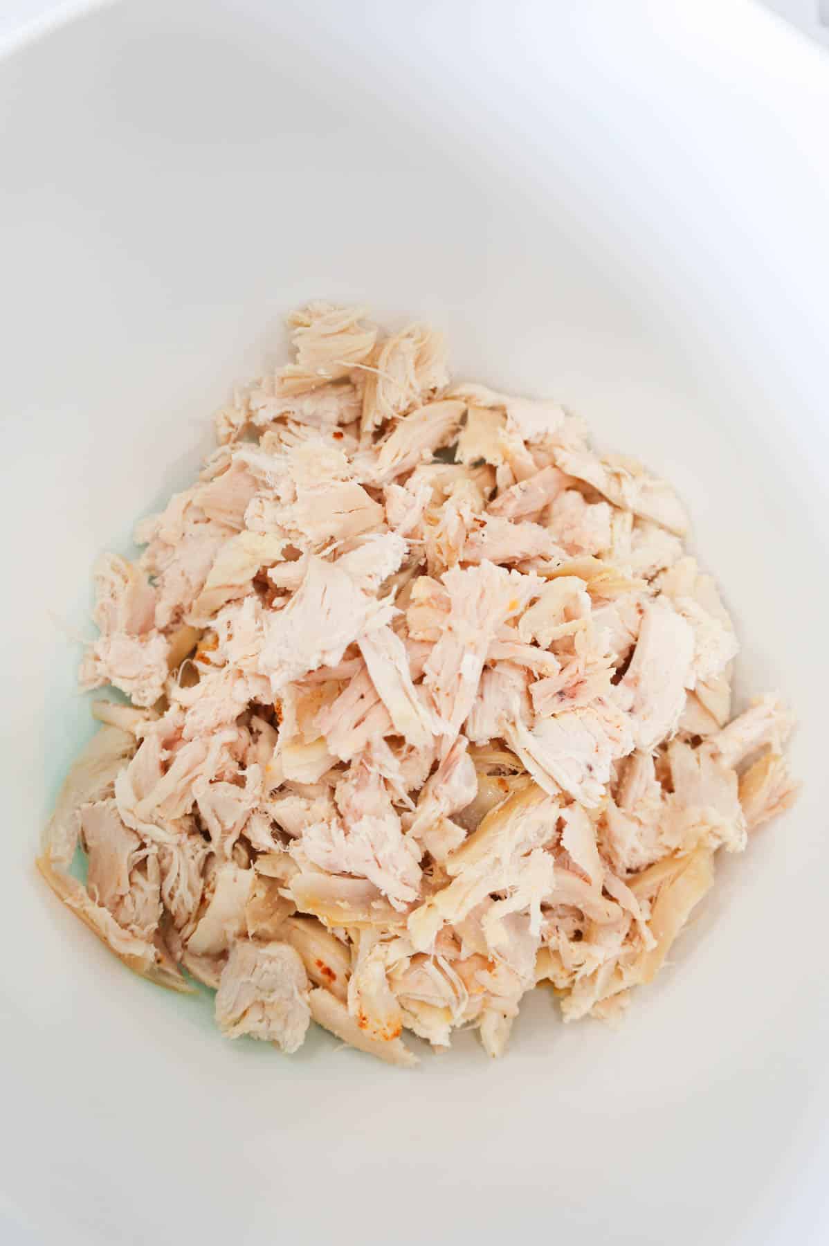 shredded chicken in a mixing bowl