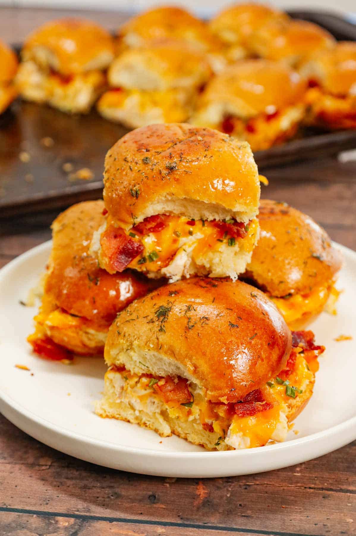 Chicken Bacon Ranch Sliders are the perfect handheld sandwich loaded with shredded rotisserie chicken, crumbled bacon, ranch dressing, chives and cheddar cheese.