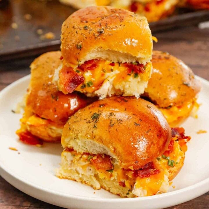 Chicken Bacon Ranch Sliders are the perfect handheld sandwich loaded with shredded rotisserie chicken, crumbled bacon, ranch dressing, chives and cheddar cheese.