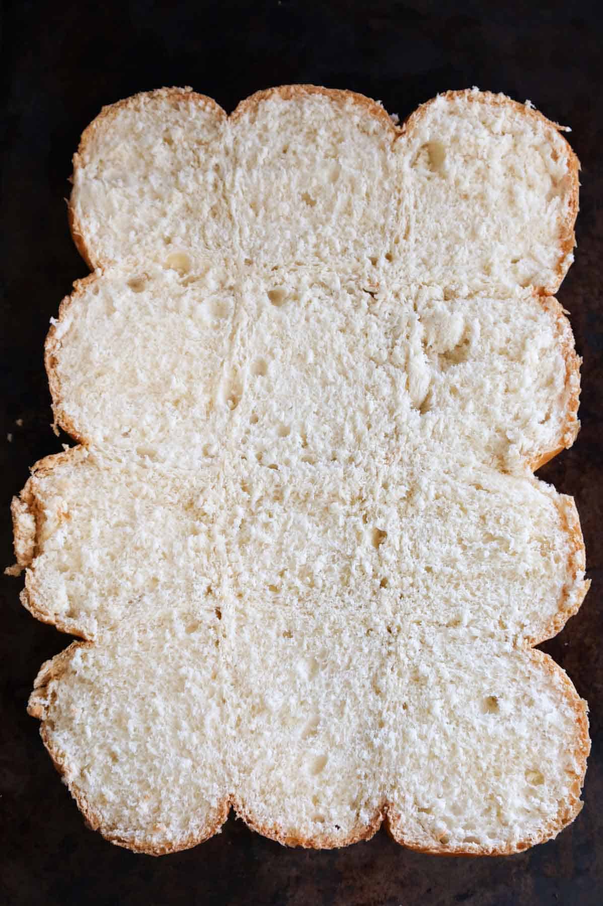 bottoms of dinner rolls on a baking sheet